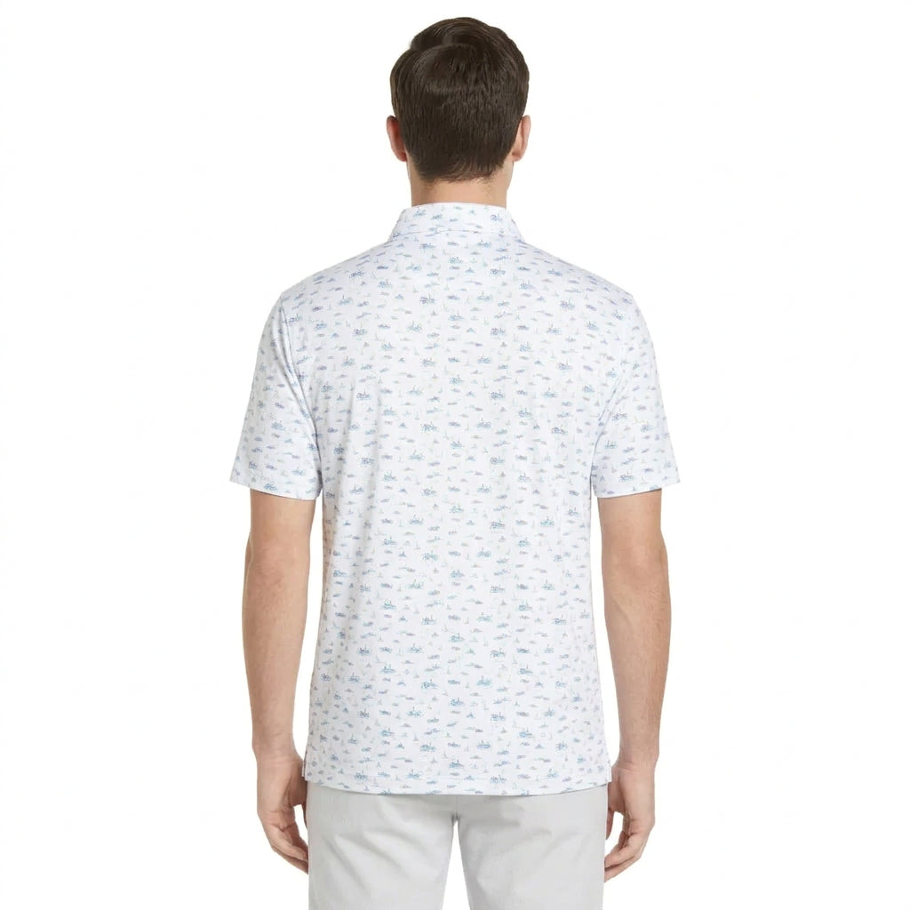 A man modeling a short-sleeve polo shirt with a white base and a light blue all-over micro-pattern, paired with light gray pants, against a plain white background.
