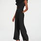केल्विन क्लेन महिलाओं के लिए स्लीवलेस बेल्टेड जंपसूट, काला, साइज़ 4