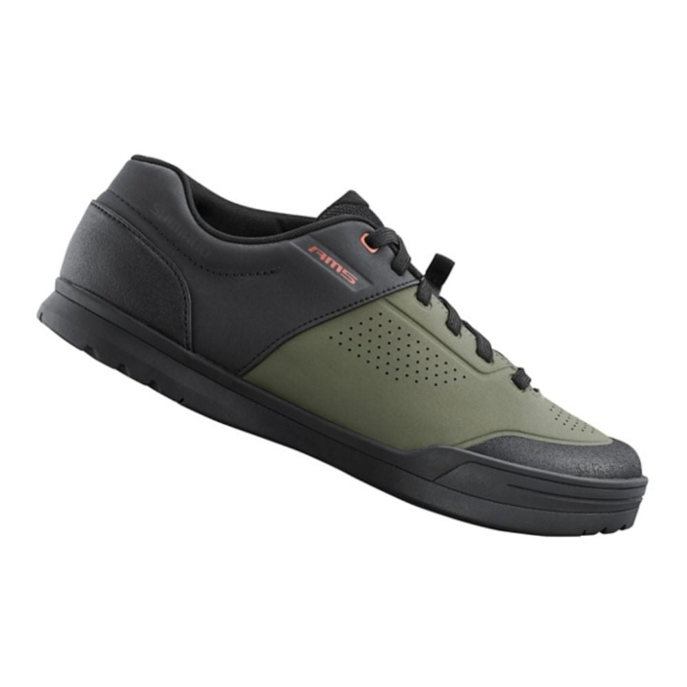 Green and black cycling shoe on a white background