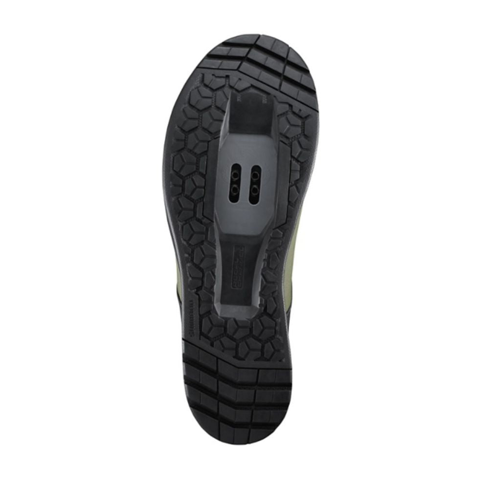 Close-up of a black shoe sole with tread pattern on a white background