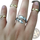 Adjustable Silver Hands Embracing Ring with Red Gemstone